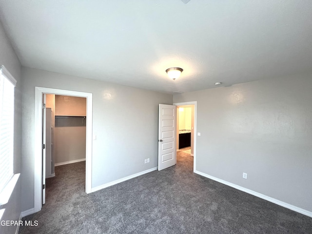 3720 Hill Top Place, El Paso, TX 79938 - unfurnished bedroom with dark colored carpet and a spacious closet