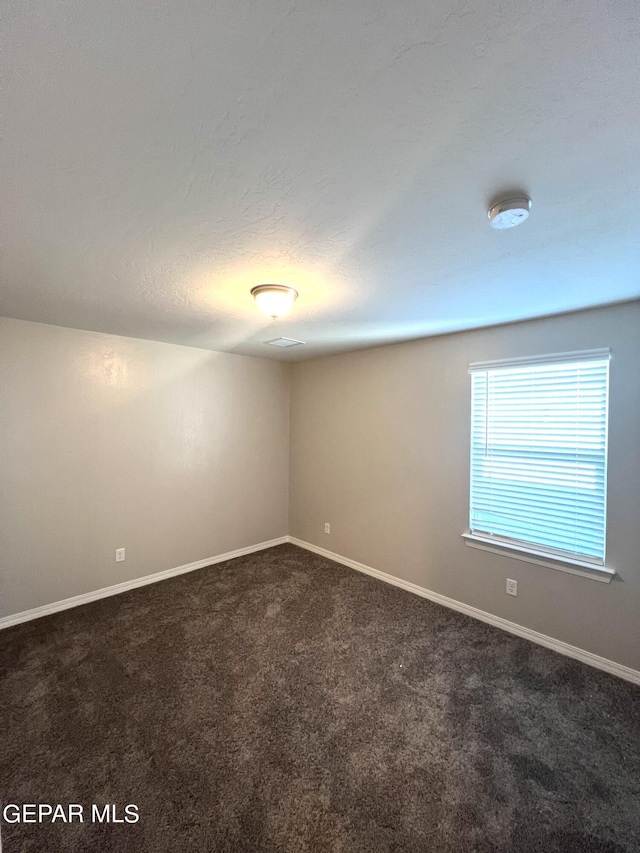 3720 Hill Top Place, El Paso, TX 79938 - spare room with dark colored carpet and a smoke detector
