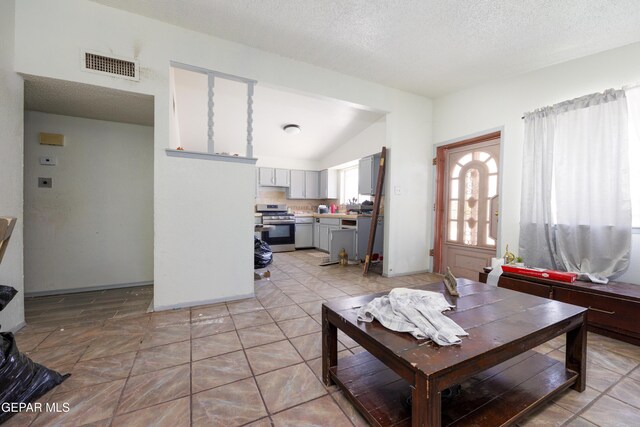 123 Marquita Ln, El Paso, TX 79915 - living area with vaulted ceiling and a textured ceiling