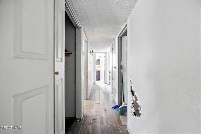 123 Marquita Ln, El Paso, TX 79915 - corridor featuring a textured ceiling and wood-type flooring