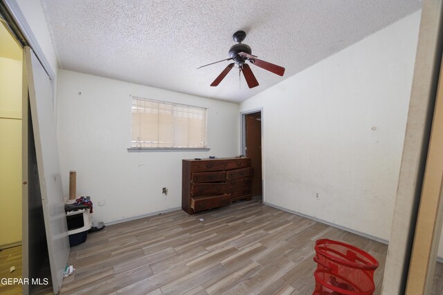 123 Marquita Ln, El Paso, TX 79915 - unfurnished bedroom with wood finished floors, a textured ceiling, a closet, and a ceiling fan