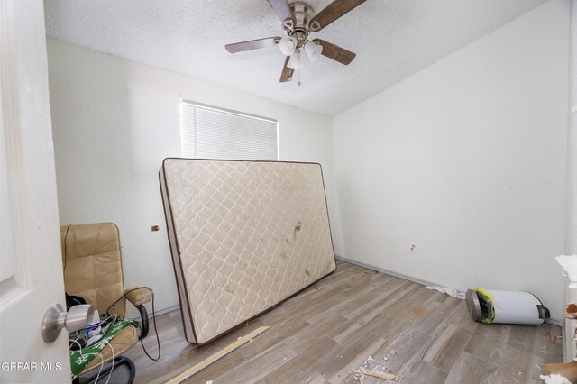 123 Marquita Ln, El Paso, TX 79915 - unfurnished bedroom with wood finished floors, a textured ceiling, and ceiling fan