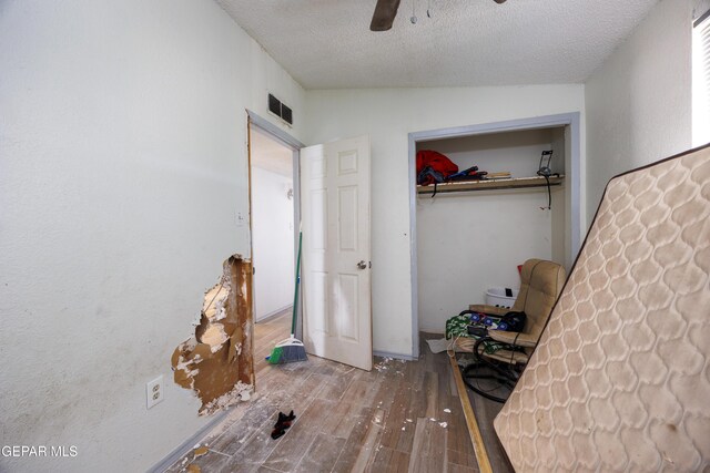 123 Marquita Ln, El Paso, TX 79915 - unfurnished bedroom featuring hardwood / wood-style floors, a textured ceiling, a closet, ceiling fan, and lofted ceiling
