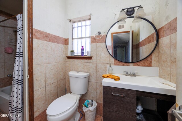 123 Marquita Ln, El Paso, TX 79915 - full bathroom featuring tile walls and vanity
