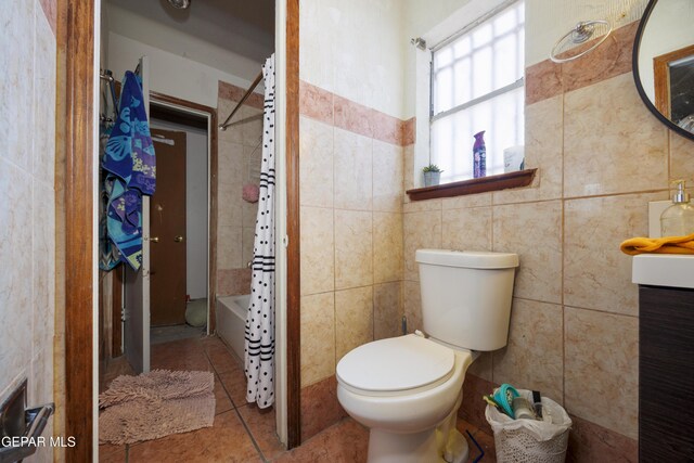 123 Marquita Ln, El Paso, TX 79915 - bathroom with tile walls, shower / bath combo with shower curtain, tile patterned flooring, and vanity
