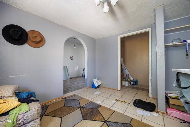 123 Marquita Ln, El Paso, TX 79915 - interior space featuring arched walkways, tile patterned floors, and a textured ceiling