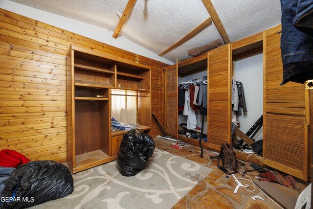 123 Marquita Ln, El Paso, TX 79915 - bedroom with a textured ceiling, lofted ceiling, and wood walls