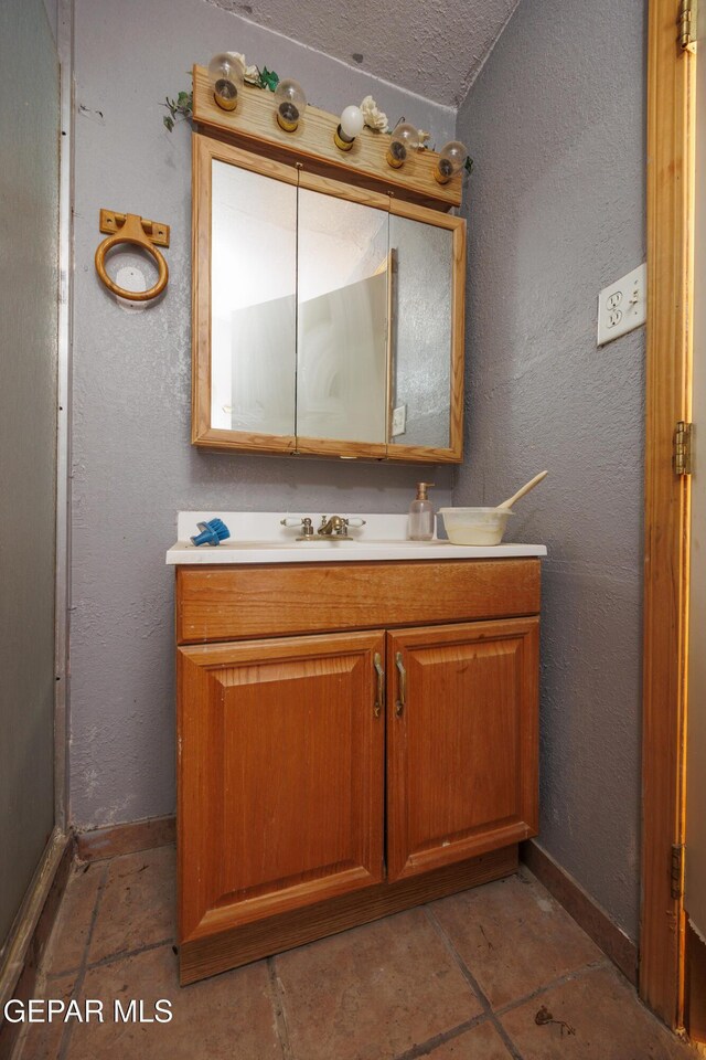 123 Marquita Ln, El Paso, TX 79915 - bathroom with vanity and a textured wall
