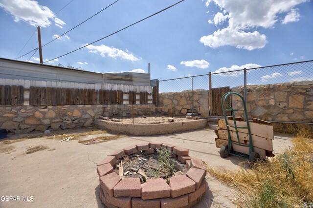 123 Marquita Ln, El Paso, TX 79915 - fenced backyard with a fire pit