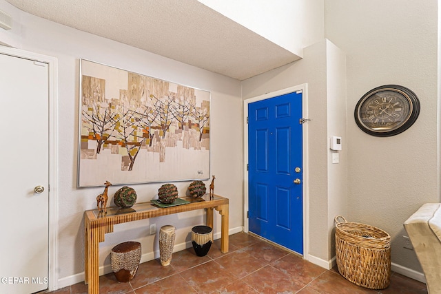 700 Milton Henry Ave, El Paso, TX 79932 - entryway featuring dark tile patterned flooring and a textured ceiling