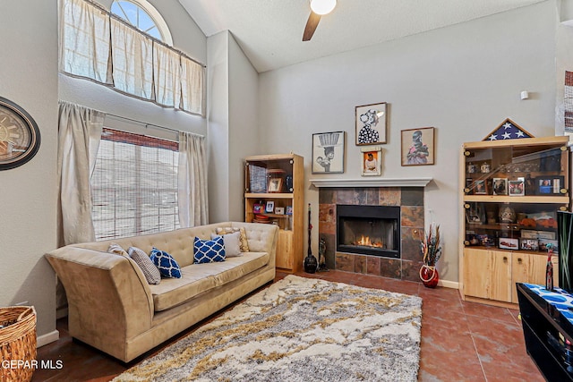 700 Milton Henry Ave, El Paso, TX 79932 - living room featuring lofted ceiling, a fireplace, ceiling fan, and tile patterned flooring