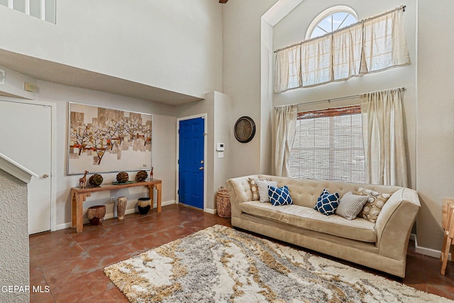 700 Milton Henry Ave, El Paso, TX 79932 - tiled living room featuring a towering ceiling and baseboards