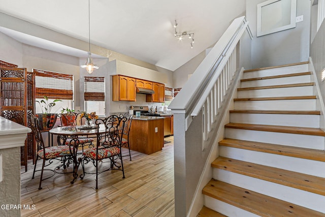 700 Milton Henry Ave, El Paso, TX 79932 - dining room featuring stairway, light wood-type flooring, and vaulted ceiling
