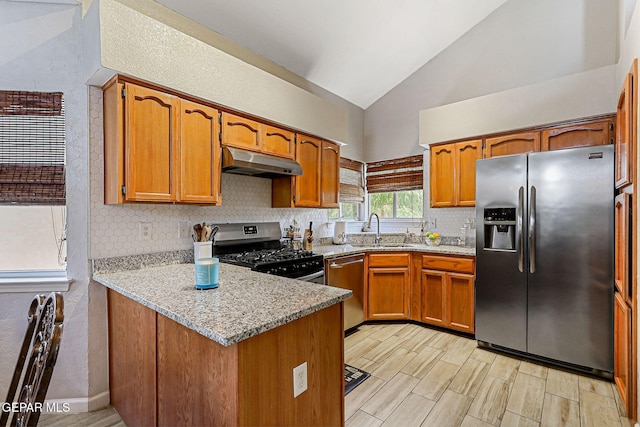 700 Milton Henry Ave, El Paso, TX 79932 - kitchen featuring appliances with stainless steel finishes, under cabinet range hood, a peninsula, brown cabinets, and backsplash