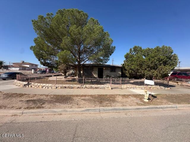 7190 Fatima Ave, El Paso, TX 79915 - view of property hidden behind natural elements with a fenced front yard