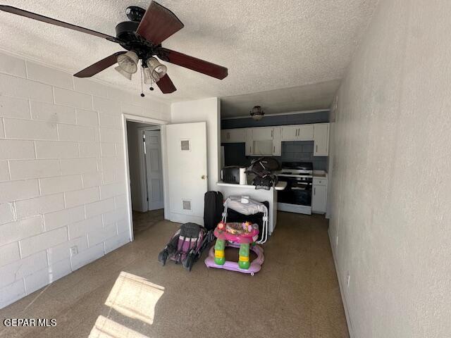 7190 Fatima Ave, El Paso, TX 79915 - playroom with a textured ceiling, a ceiling fan, and carpet floors