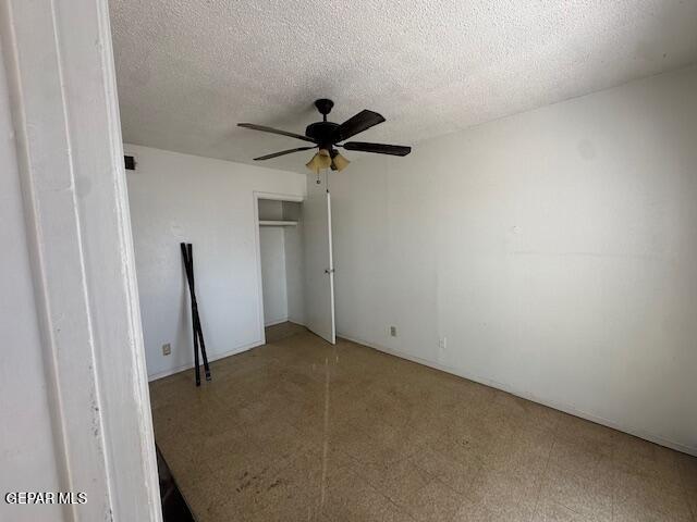 7190 Fatima Ave, El Paso, TX 79915 - unfurnished bedroom with a closet, a textured ceiling, and a ceiling fan