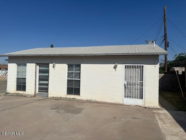 7190 Fatima Ave, El Paso, TX 79915 - back of property with concrete block siding, a patio area, and a shingled roof