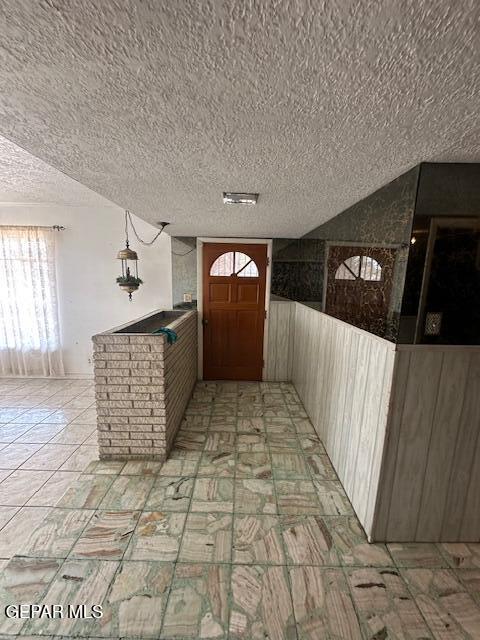 7190 Fatima Ave, El Paso, TX 79915 - entryway featuring a textured ceiling and healthy amount of natural light