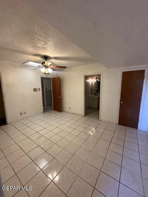 7190 Fatima Ave, El Paso, TX 79915 - spare room with a textured ceiling, light tile patterned flooring, and a ceiling fan