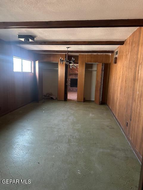 7190 Fatima Ave, El Paso, TX 79915 - basement with wooden walls and a textured ceiling