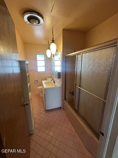 7190 Fatima Ave, El Paso, TX 79915 - full bathroom featuring vanity, tile patterned floors, and shower / bath combination with glass door