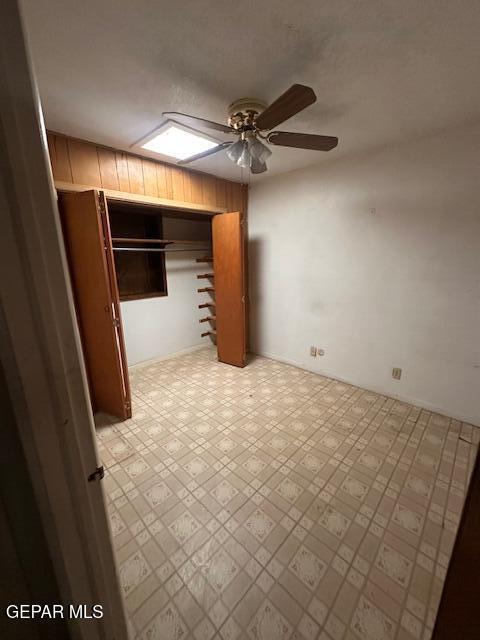 7190 Fatima Ave, El Paso, TX 79915 - unfurnished bedroom with tile patterned floors, a ceiling fan, and a skylight