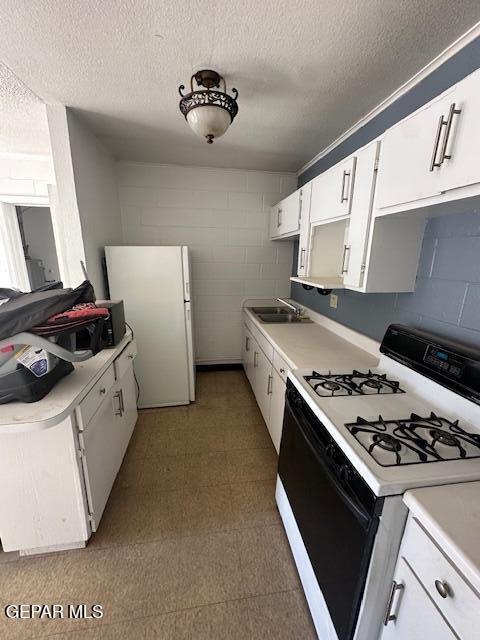 7190 Fatima Ave, El Paso, TX 79915 - kitchen with white appliances, light countertops, a textured ceiling, white cabinets, and tile patterned floors