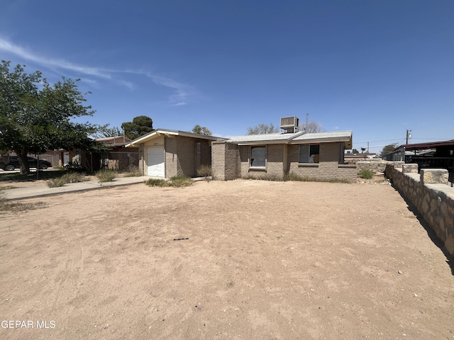 8725 Clavel Dr, El Paso, TX 79907 - view of front of house featuring an attached garage, brick siding, and concrete driveway