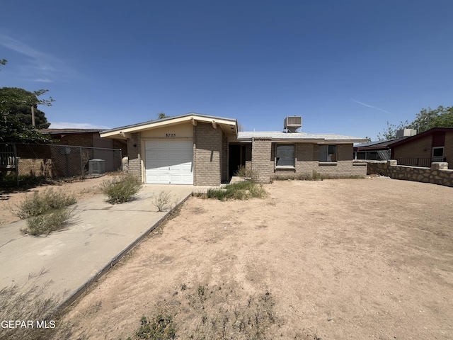 8725 Clavel Dr, El Paso, TX 79907 - view of front facade featuring brick siding, an attached garage, and driveway