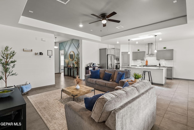 13699 Kathys Ct, El Paso, TX 79928 - living room with a raised ceiling, light tile patterned floors, ceiling fan, and recessed lighting