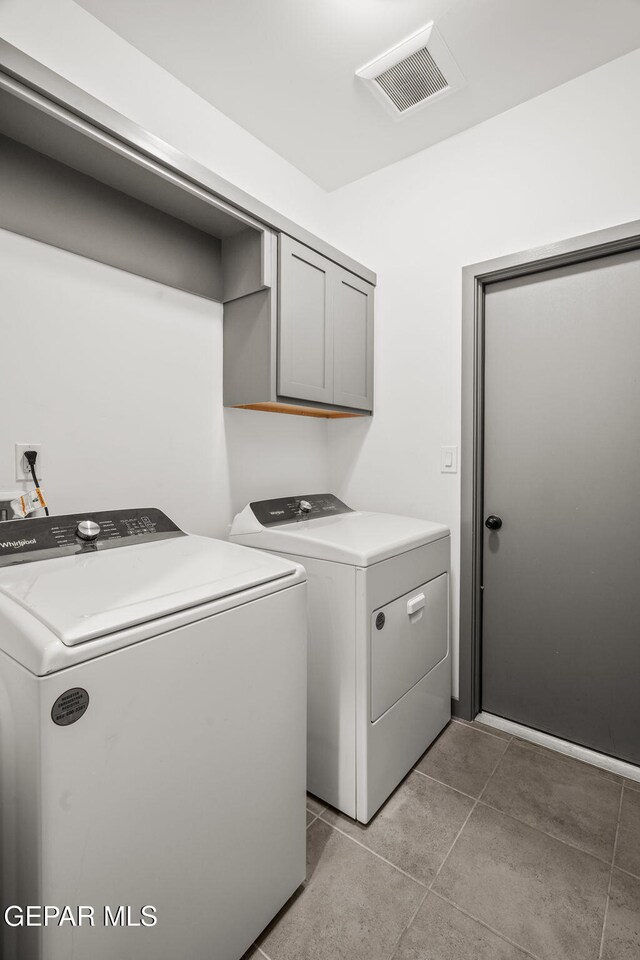 13699 Kathys Ct, El Paso, TX 79928 - washroom with separate washer and dryer, cabinet space, and light tile patterned flooring