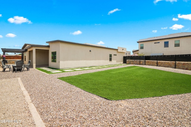 13699 Kathys Ct, El Paso, TX 79928 - back of property featuring a fenced backyard, a patio area, and stucco siding
