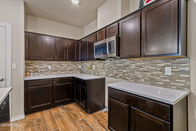 5465 Limestone Dr, El Paso, TX 79934 - kitchen featuring stainless steel microwave, dark brown cabinetry, decorative backsplash, light countertops, and light wood finished floors