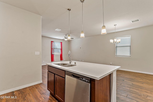5465 Limestone Dr, El Paso, TX 79934 - kitchen featuring dishwasher, wood finished floors, light countertops, pendant lighting, and a center island with sink