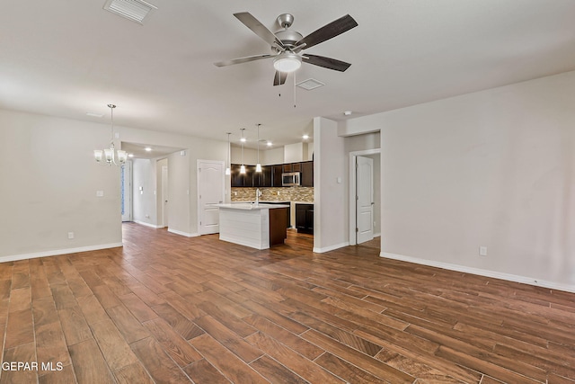 5465 Limestone Dr, El Paso, TX 79934 - unfurnished living room featuring a chandelier, dark wood-style flooring, and ceiling fan