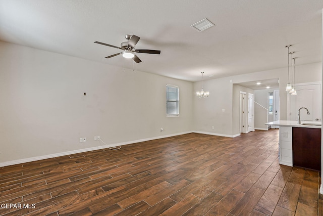5465 Limestone Dr, El Paso, TX 79934 - unfurnished living room featuring dark wood-type flooring, ceiling fan, and a chandelier
