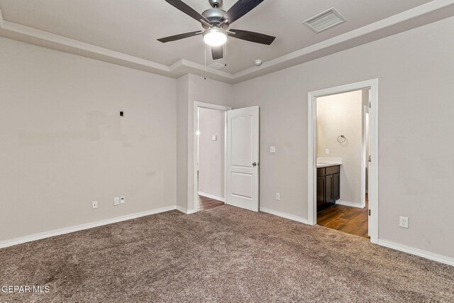 5465 Limestone Dr, El Paso, TX 79934 - unfurnished bedroom featuring dark colored carpet, a raised ceiling, ensuite bathroom, and a ceiling fan