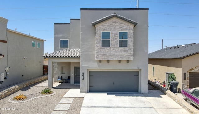 3725 Surmise St, El Paso, TX 79938 - view of front of home with stucco siding, a tile roof, a garage, concrete driveway, and stone siding