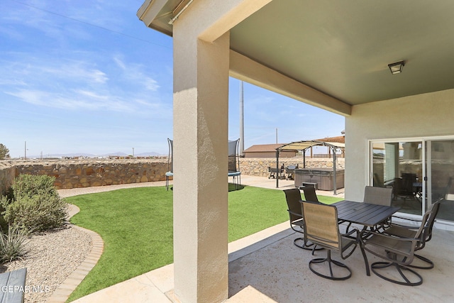 3725 Surmise St, El Paso, TX 79938 - fenced backyard featuring a hot tub, a patio area, and outdoor dining space