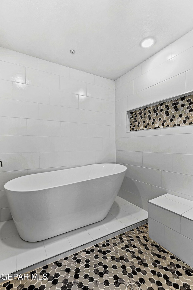 3725 Surmise St, El Paso, TX 79938 - full bathroom featuring tile walls and a freestanding tub