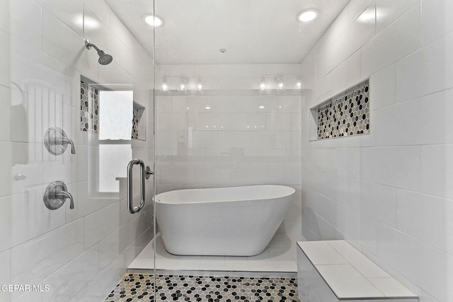 3725 Surmise St, El Paso, TX 79938 - full bathroom featuring a freestanding tub, a stall shower, tile walls, and tile patterned floors