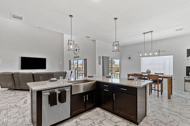 3725 Surmise St, El Paso, TX 79938 - kitchen featuring dishwasher, light marble finish flooring, open floor plan, light stone counters, and hanging light fixtures