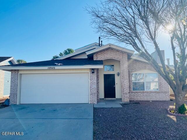10940 Golden Pond Dr, El Paso, TX 79934 - view of front facade featuring brick siding, driveway, and a garage