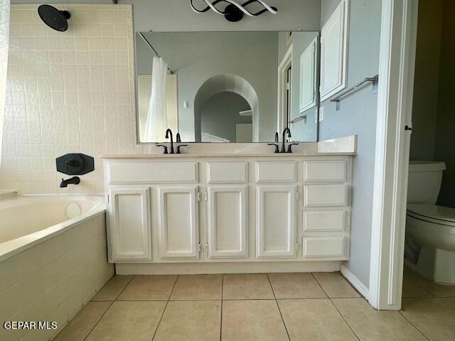 10940 Golden Pond Dr, El Paso, TX 79934 - full bathroom featuring tile patterned floors, double vanity, and tiled shower / bath combo