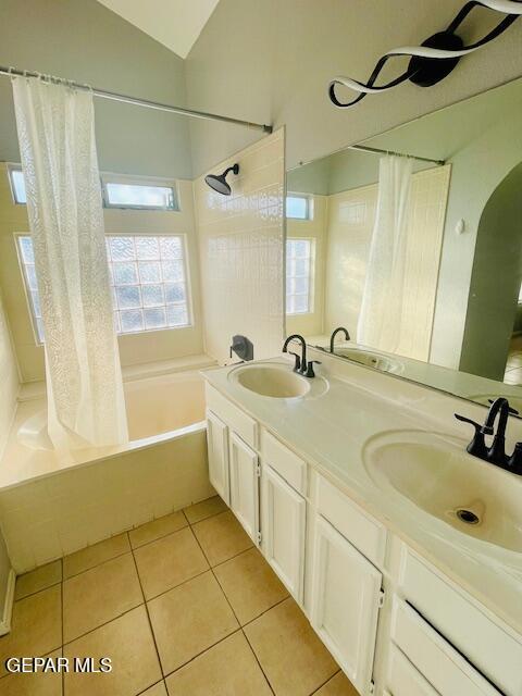 10940 Golden Pond Dr, El Paso, TX 79934 - full bathroom with shower / bath combo with shower curtain, tile patterned flooring, double vanity, and lofted ceiling
