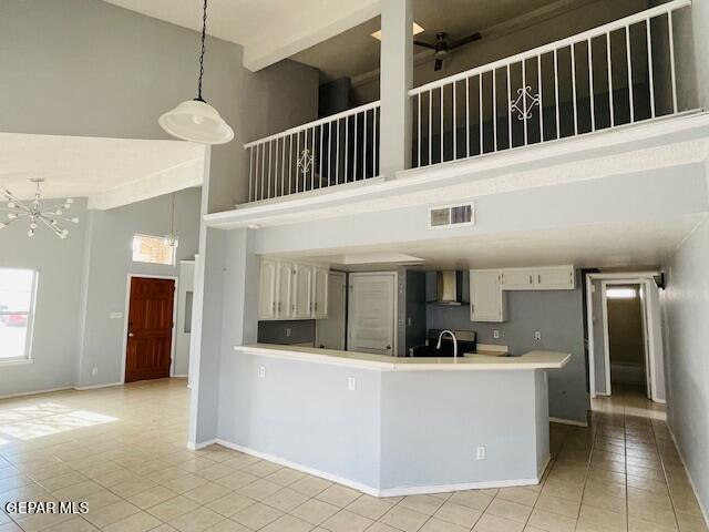 10940 Golden Pond Dr, El Paso, TX 79934 - kitchen featuring a high ceiling, light tile patterned flooring, extractor fan, light countertops, and a ceiling fan