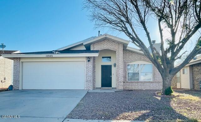 10940 Golden Pond Dr, El Paso, TX 79934 - ranch-style house with brick siding, a garage, and driveway