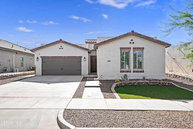 912 Malven Pl, El Paso, TX 79928 - mediterranean / spanish-style house featuring concrete driveway, stucco siding, an attached garage, and a tile roof