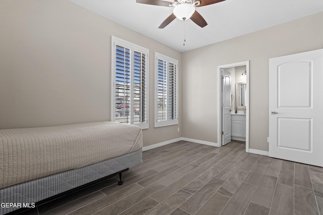 912 Malven Pl, El Paso, TX 79928 - unfurnished bedroom with wood tiled floors, ceiling fan, and connected bathroom